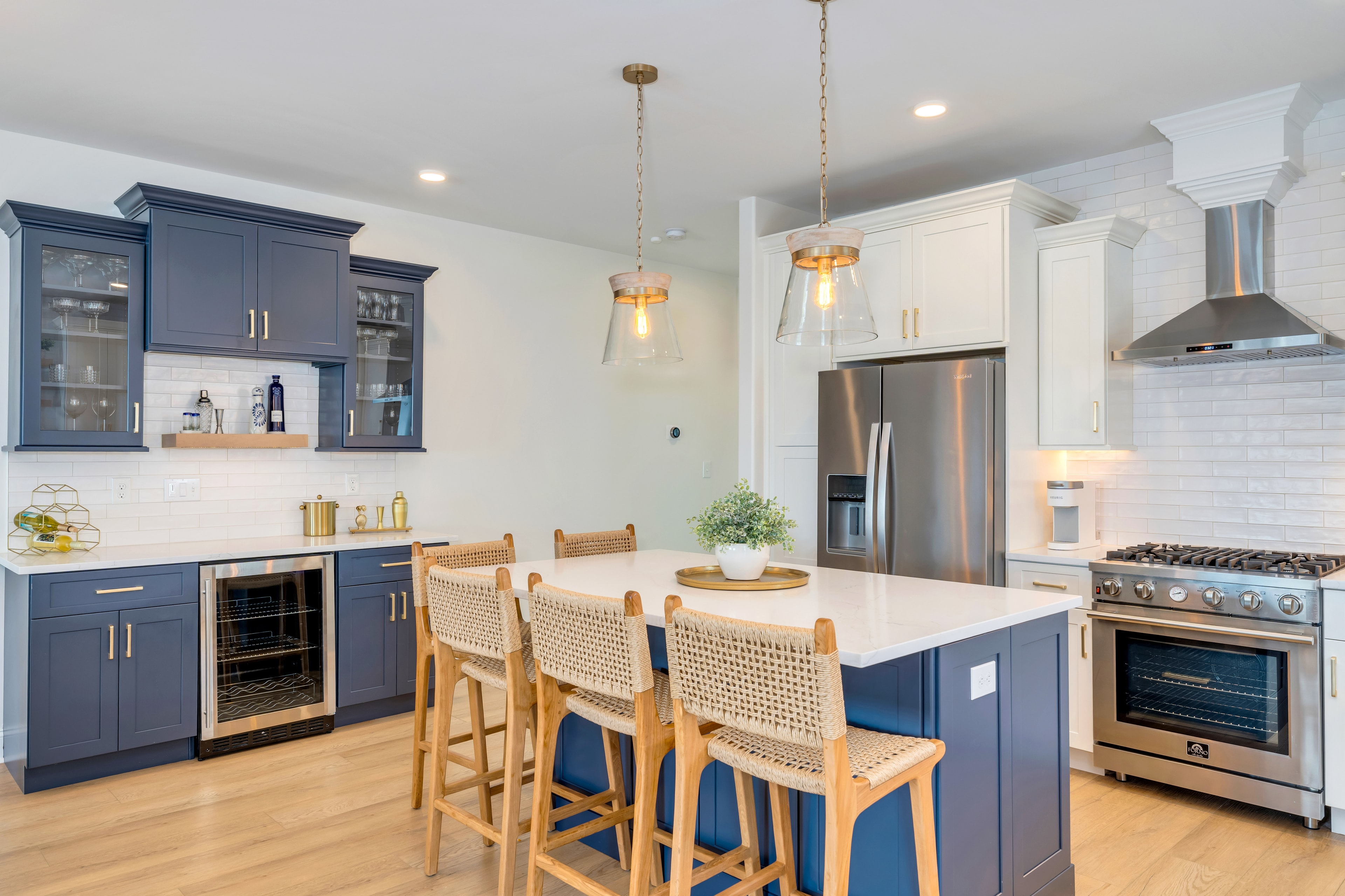 Kitchen with blue island and gold hardware