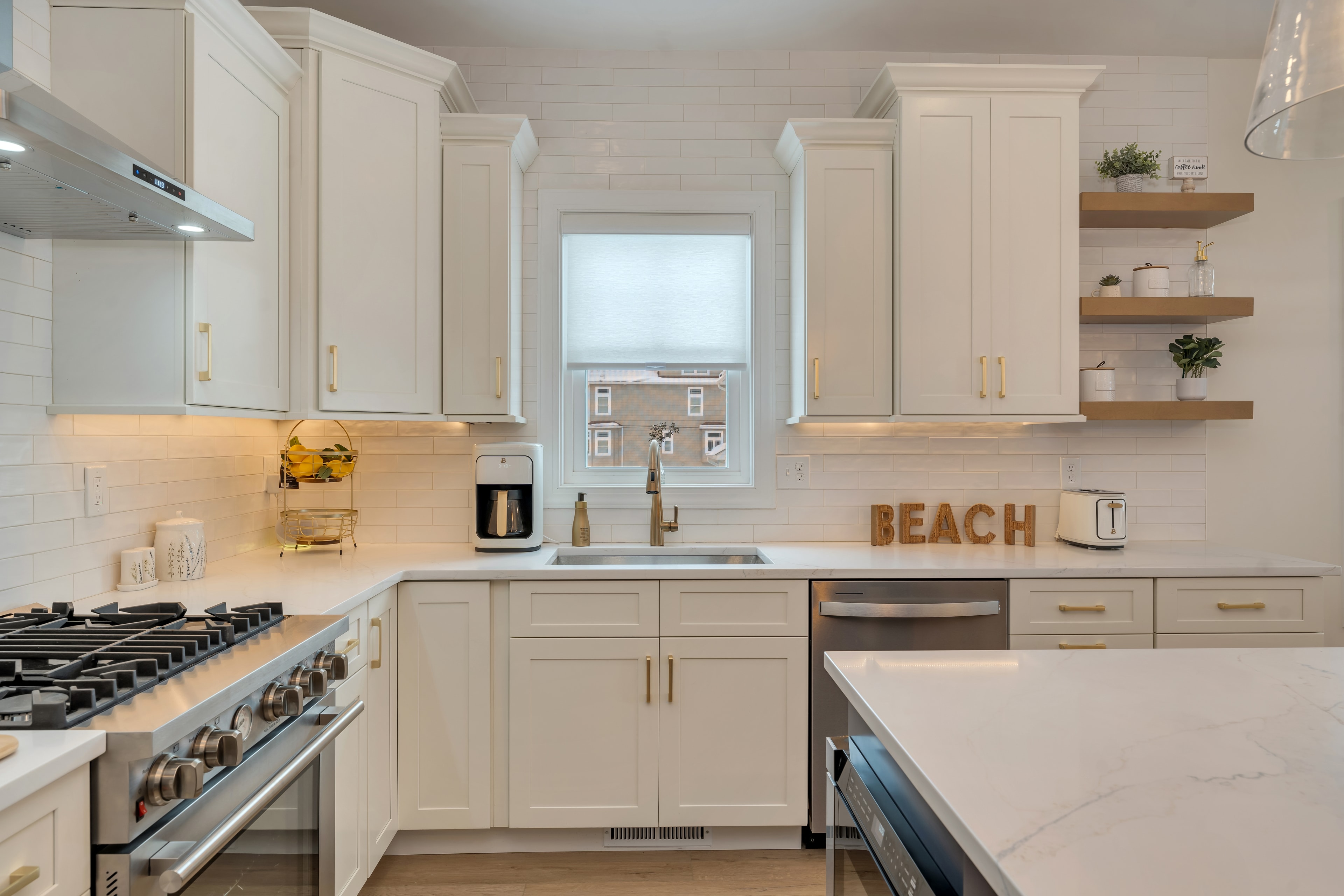 Kitchen sink wall with white cabinets