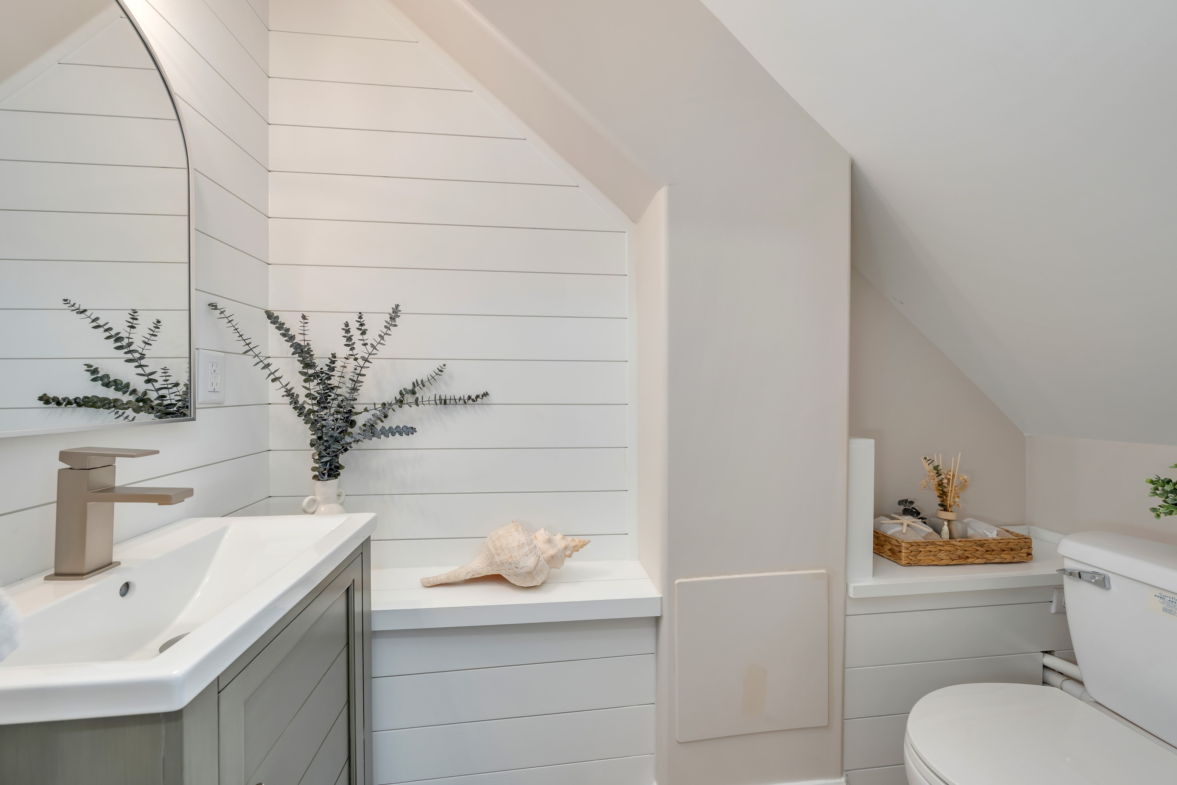Powder room with shiplap walls and coastal décor